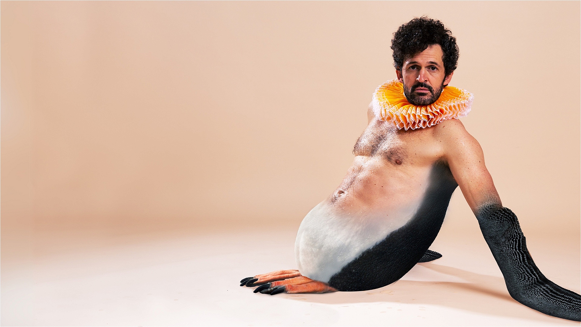 A man with an orange ruff, his upper half is undressed and his lower body is the body of a penguin.