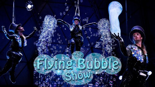Maxwell the Bubbleologist is flying in the air making millions of bubbles