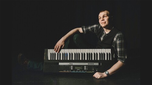 A musical comedian lying on the floor
