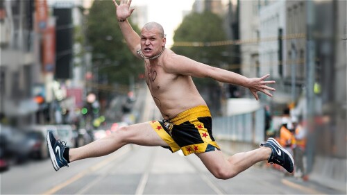 Furiozo leaps across a road bare-chested, with limbs splayed in every direction.