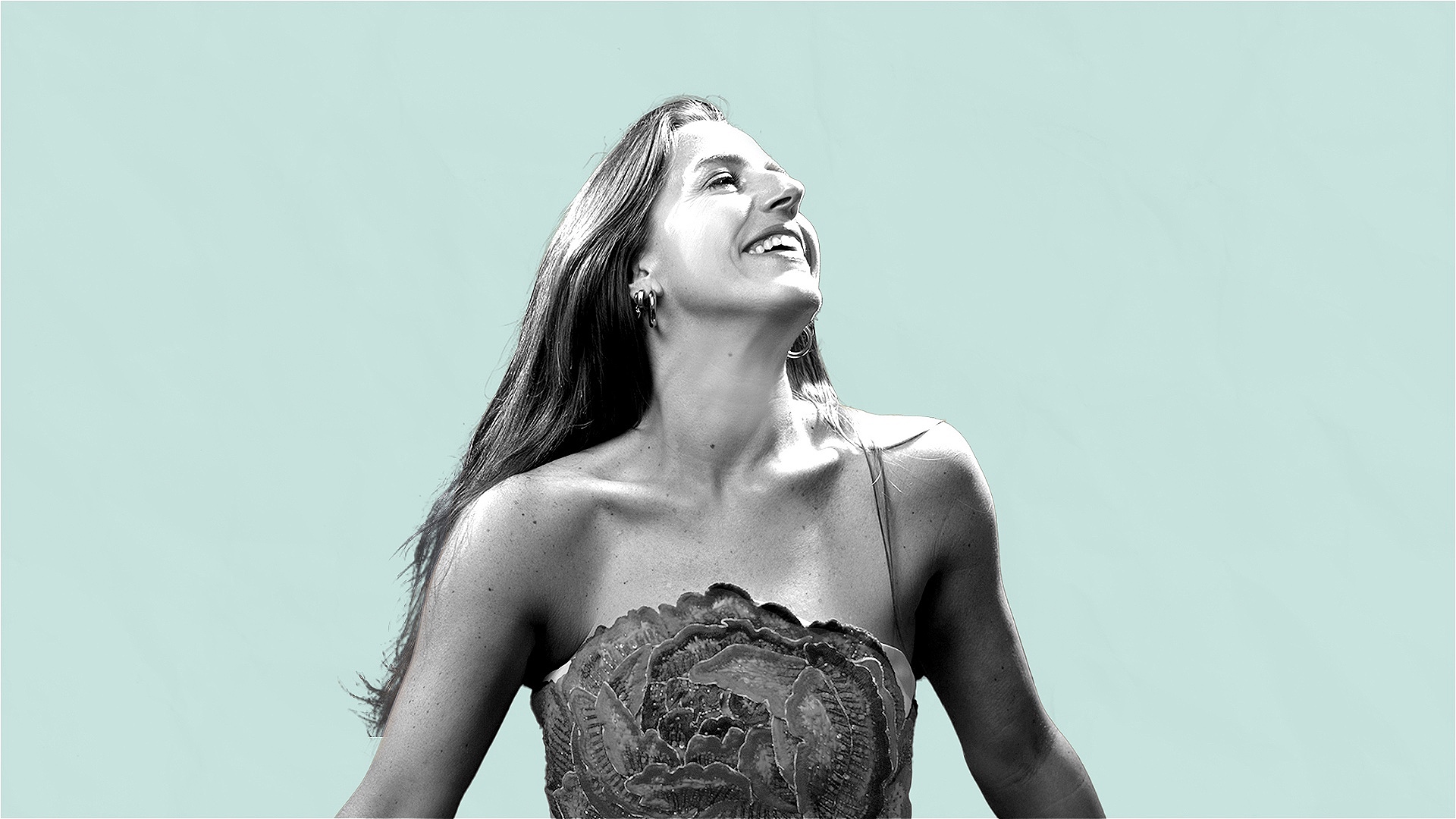 balck and white image of a women looking to the right wearing a dress agagint a blue background