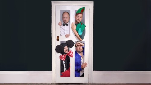 White door in the middle of a plain dark wall with white skirting running along bottom of the wall. The door has four panels with performer Neil Frost in four different costumes. Top left door panel - white shirt and black bowtie costume, Top right door 