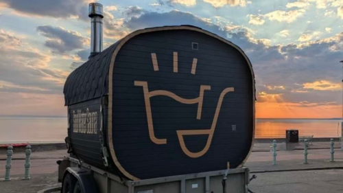 A portable sauna with the sunset in the background 