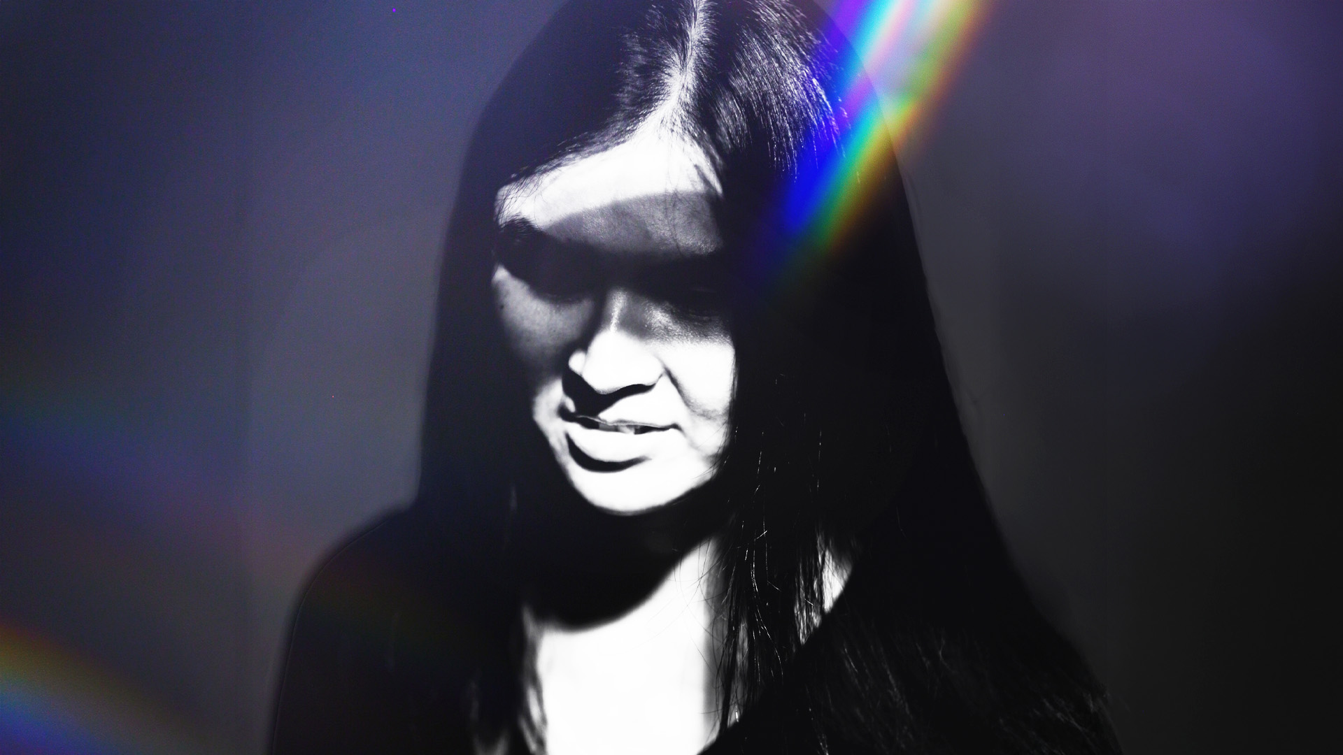 A black and white image of a woman looking down 