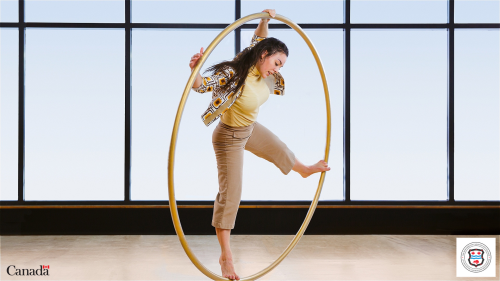 a female acroabatic performer balancing inside a large hoop 
