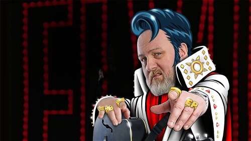 Mitch Benn's face in a template of an animated elvis presley image. He looks up at the screen and points his ring filled fingers upto the viewer.