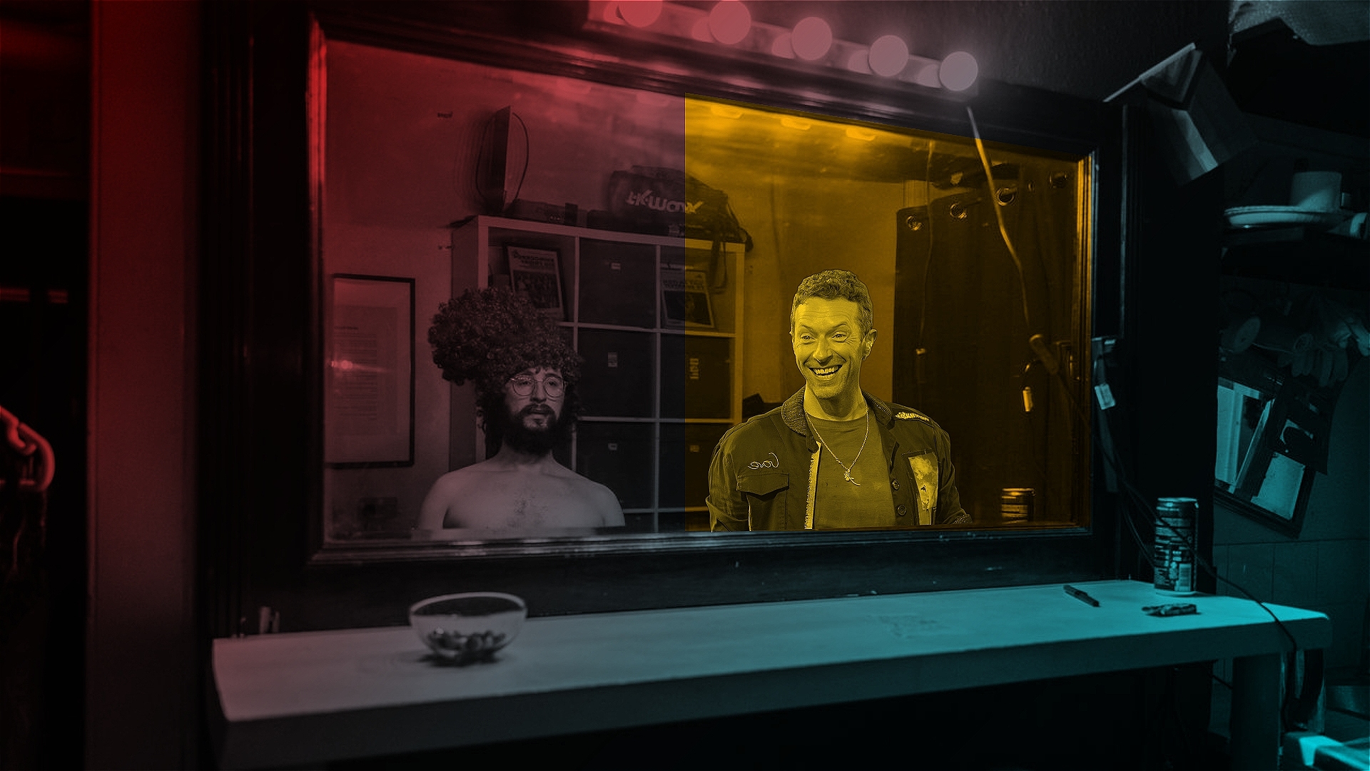 Will and Chris Martin look into a mirror. The world around them is colourful, but the world inside Chris' mirror is only Yellow. Chris Martin Grins.