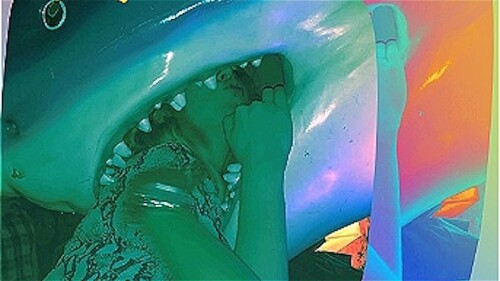 A girl with her head in a shark's mouth