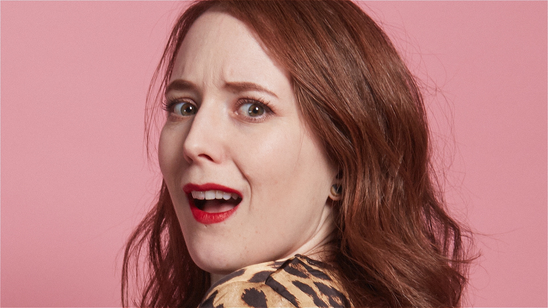 Beautiful ginger woman looking over her shoulder, shocked