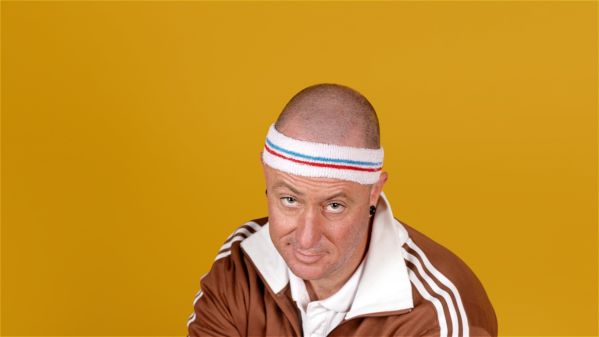 darryl in a tennis headband, looking up at the camera 