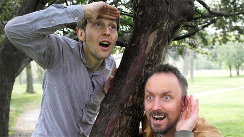 Comedians Tom Skelton and Tom Gk pose next to a tree 