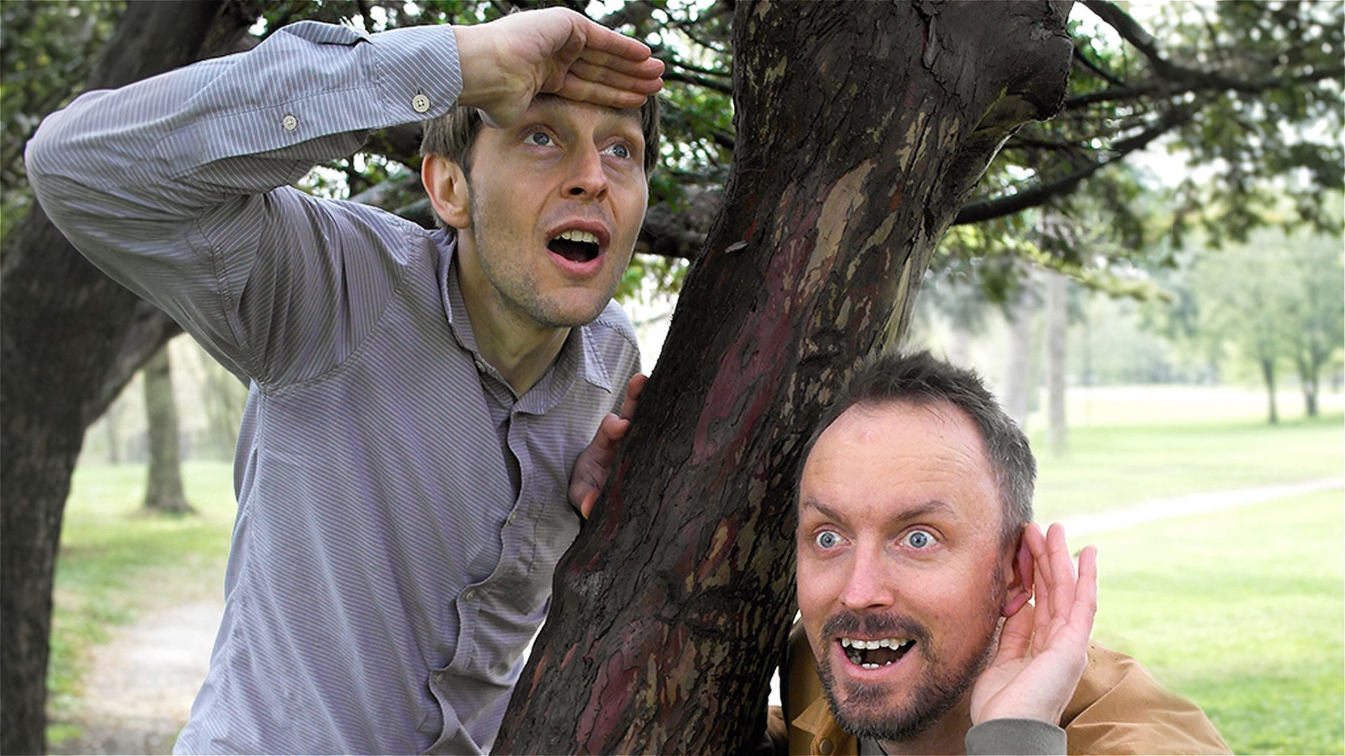 Comedians Tom Skelton and Tom Gk pose next to a tree 