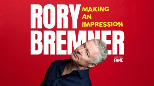 Rory Bremner tilts his head against a red background