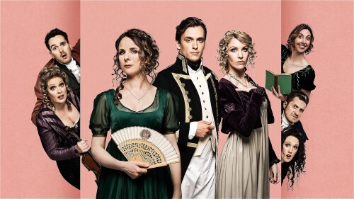 8 people in Regency costume stand and look out towards the viewer. They are holding Regency era props – a violin, a fan, a book.