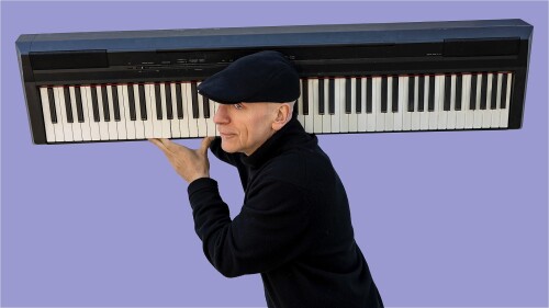 A man is furtively running with a piano on his shoulder in front of a purple background